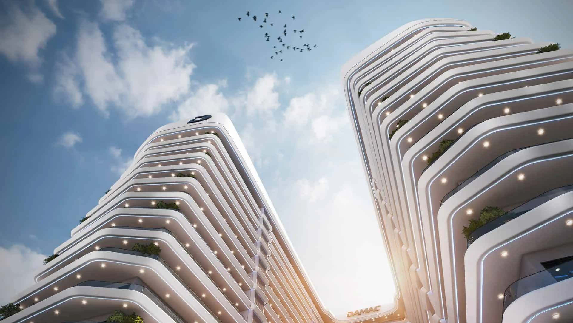 Curved ELO 2 residential tower with balconies overlooking parkland in DAMAC Hills 2