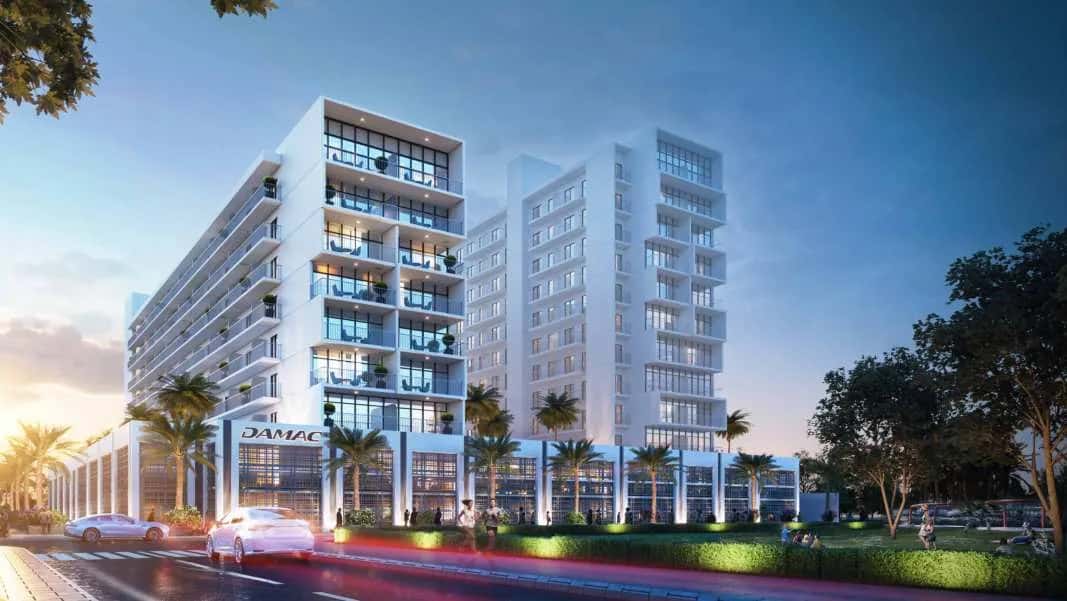 Evergreens tower at DAMAC Hills 2, a white residential building surrounded by parklands in Madinat Hind 4, Dubai
