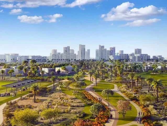 Greenspoint townhouse community facades amid landscaped greenery in Emaar South, Dubai