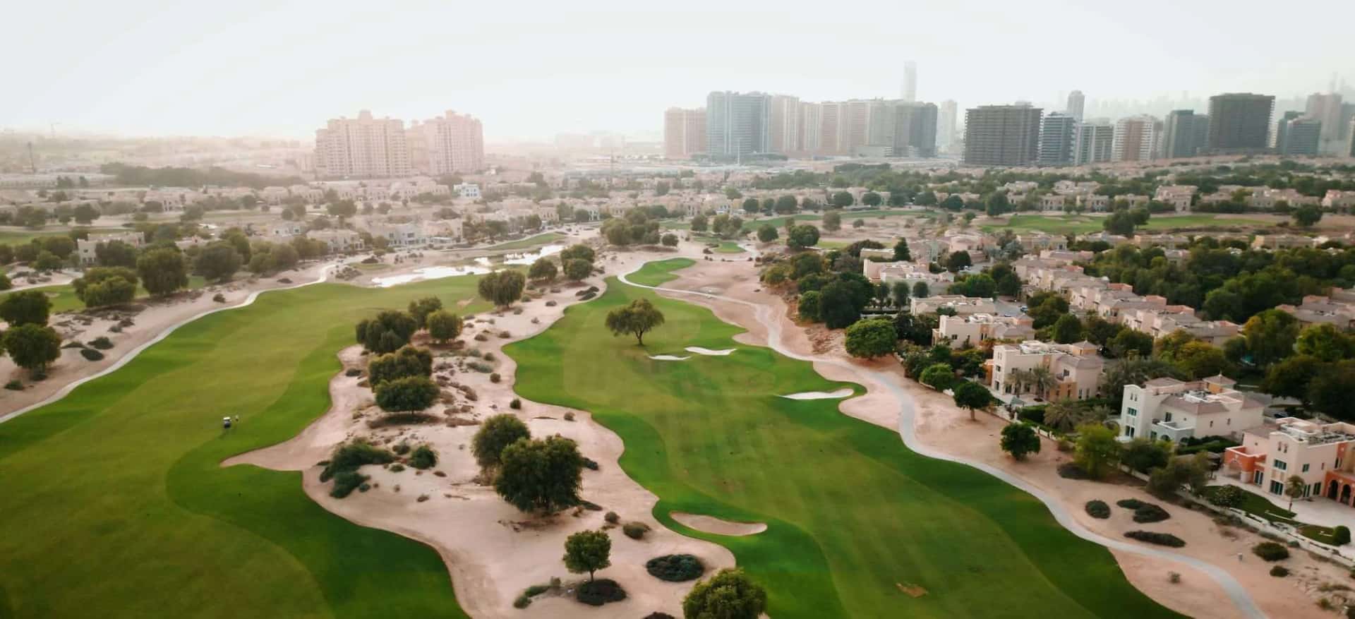 Aurel1a Residence tower exterior in Dubai Sports City with pool deck amenities