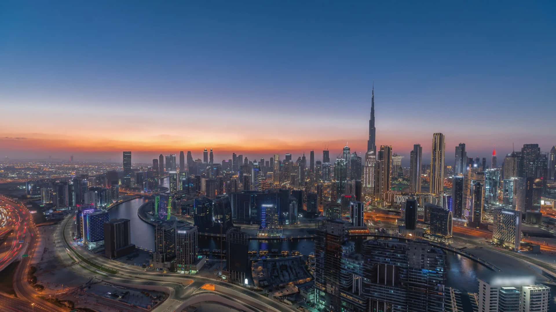One Sky Park twin towers with curved facade and sky bridge in Jumeirah Village Circle, Dubai